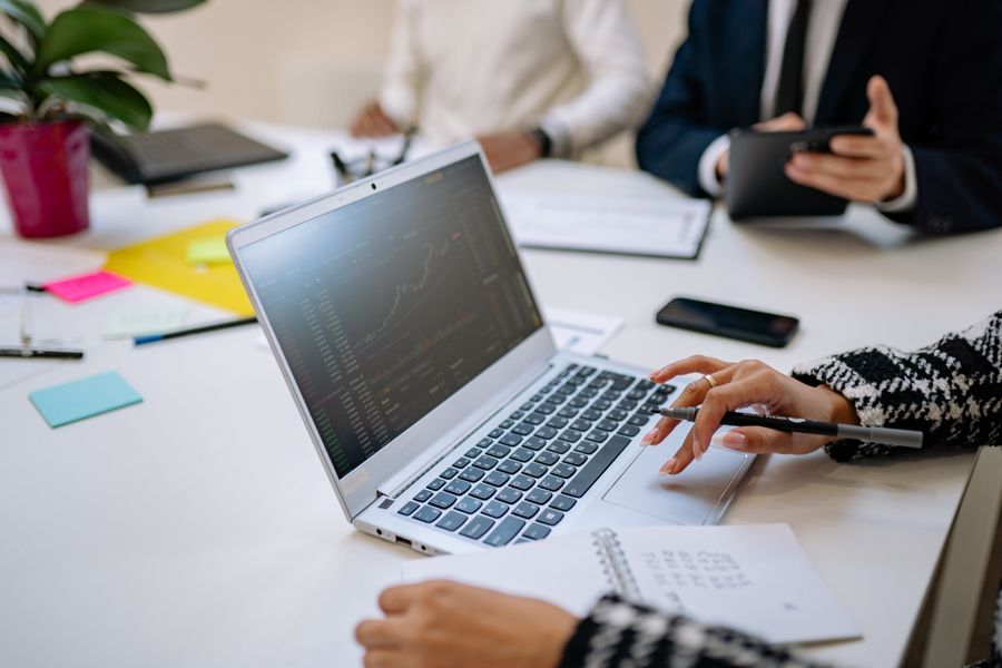 Professionals reviewing a laptop in a meeting
