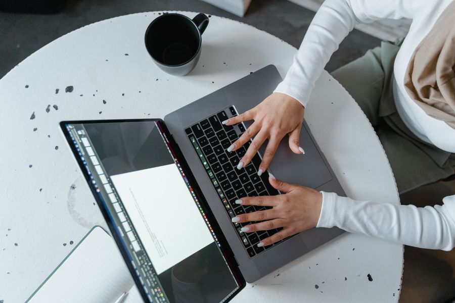 Professional building a resume and profile on a laptop
