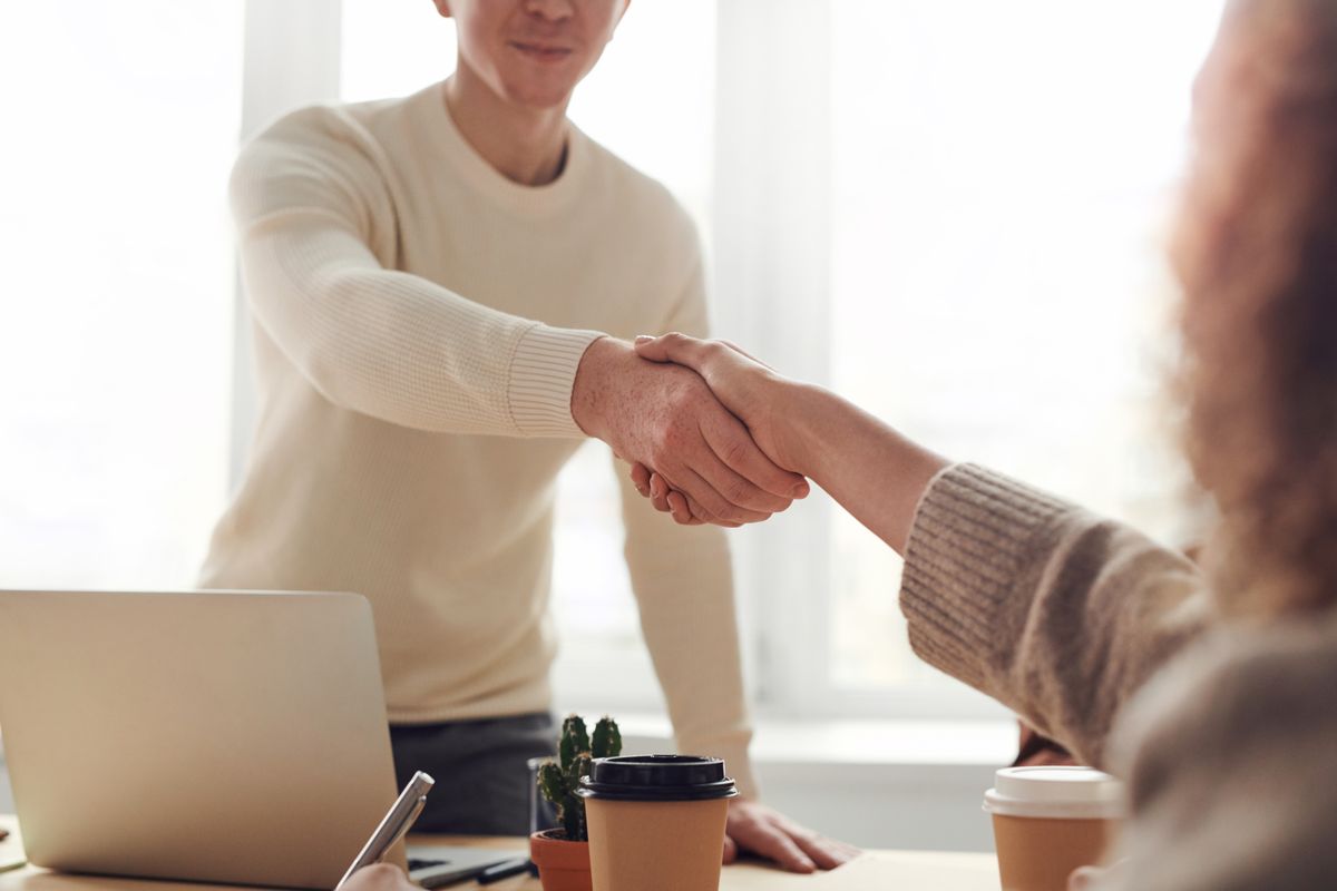 Recruiters discussing hiring strategy with a laptop